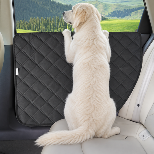 Dog using a black quilted car door protector during a road trip